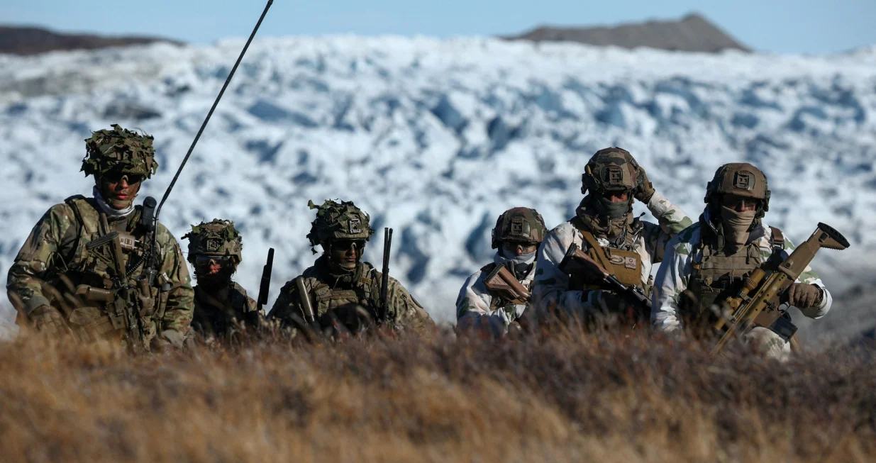 FILE PHOTO: Members of the Danish armed forces practice looking for potential threats during a military drill as Danish, Swedish and Norwegian home guard units together with Danish, German and French troops take part in joint military drills in Kangerlussuaq, Greenland, September 17, 2025. REUTERS/Guglielmo Mangiapane/File Photo/Guglielmo Mangiapane