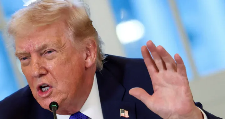 FILE PHOTO: U.S. President Donald Trump wearing a "happy Trump" pin speaks during a meeting with oil industry executives at the White House in Washington, D.C., U.S., January 9, 2026. REUTERS/Kevin Lamarque/File Photo/Kevin Lamarque