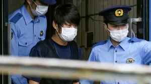 Tetsuya Yamagami, suspected of killing former Japanese premier Shinzo Abe, is escorted by police officers as he is taken to prosecutors, at Nara-nishi police station in Nara, western Japan, in this photo taken by Kyodo July 10, 2022. Mandatory credit Kyodo via REUTERS ATTENTION EDITORS - THIS IMAGE WAS PROVIDED BY A THIRD PARTY. MANDATORY CREDIT. JAPAN OUT. NO COMMERCIAL OR EDITORIAL SALES IN JAPAN. NO RESALES. NO ARCHIVES/Kyodo