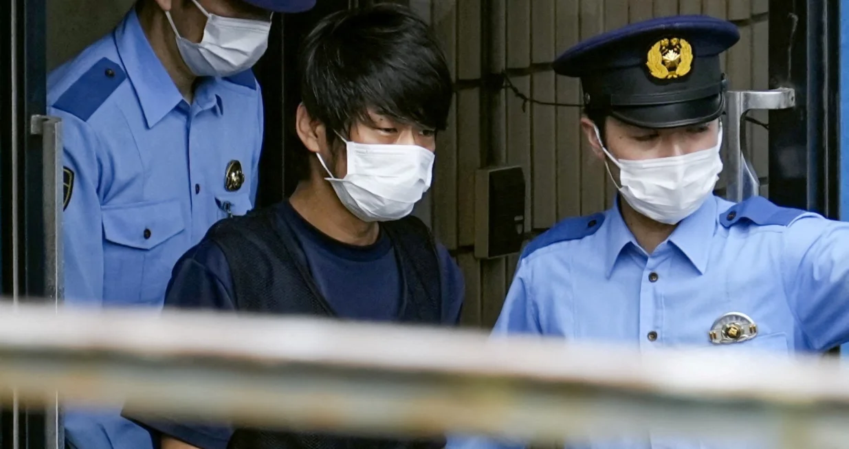 Tetsuya Yamagami, suspected of killing former Japanese premier Shinzo Abe, is escorted by police officers as he is taken to prosecutors, at Nara-nishi police station in Nara, western Japan, in this photo taken by Kyodo July 10, 2022. Mandatory credit Kyodo via REUTERS ATTENTION EDITORS - THIS IMAGE WAS PROVIDED BY A THIRD PARTY. MANDATORY CREDIT. JAPAN OUT. NO COMMERCIAL OR EDITORIAL SALES IN JAPAN. NO RESALES. NO ARCHIVES/Kyodo