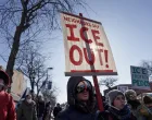 FILE PHOTO: Demonstrators carry signs condemning Immigration and Customs Enforcement (ICE) near the site where a man identified as Alex Pretti was fatally shot by federal agents trying to detain him, in Minneapolis, Minnesota, U.S., January 24, 2026. REUTERS/Tim Evans/File Photo/Tim Evans