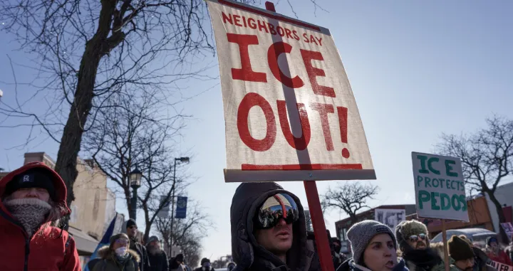 FILE PHOTO: Demonstrators carry signs condemning Immigration and Customs Enforcement (ICE) near the site where a man identified as Alex Pretti was fatally shot by federal agents trying to detain him, in Minneapolis, Minnesota, U.S., January 24, 2026. REUTERS/Tim Evans/File Photo/Tim Evans