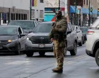 A U.S. Border Patrol agent stands in the street as a man is detained off the sidewalk, after a U.S. Immigration and Customs Enforcement (ICE) agent fatally shot Renee Nicole Good, in Minneapolis, Minnesota, U.S., January 10, 2026. REUTERS/Brian Snyder/Brian Snyder