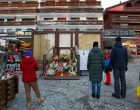 People stand by a makeshift memorial outside the "Le Constellation bar" almost a month after a deadly fire during a New Year's Eve party, in the upscale ski resort of Crans-Montana, Switzerland, January 31, 2026. REUTERS/Denis Balibouse/Denis Balibouse