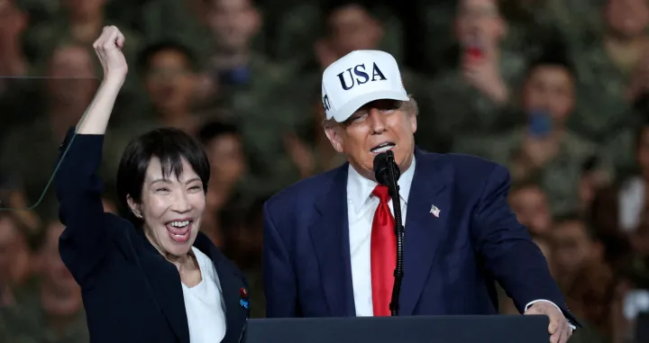 FILE PHOTO: U.S. President Donald Trump speaks as Japanese Prime Minister Sanae Takaichi gestures towards military personnel, aboard the aircraft carrier USS George Washington, during their visit to the U.S. Navy's Yokosuka base in Yokosuka, Japan, October 28, 2025. REUTERS/Kim Kyung-Hoon/File Photo/Kim Kyung-hoon