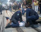 Police officers detain a protester as demonstrators gather at Town Hall Square to protest against Israeli President Isaac Herzog's state visit to Australia following a deadly mass shooting during a Jewish Hanukkah celebration at Bondi Beach on December 14, in Sydney, Australia, February 9, 2026. REUTERS/Jeremy Piper вЂЋ/Jeremy Piper