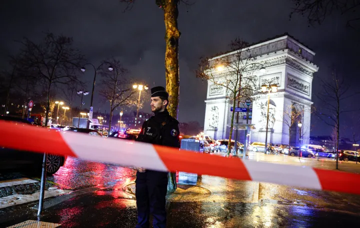 Police officer stands guard as law enforcement operate a cordon after authorities said a man armed with a knife attacked a police officer near the Arc de Triomphe in Paris, France, February 13, 2026. REUTERS/Benoit Tessier/Benoit Tessier