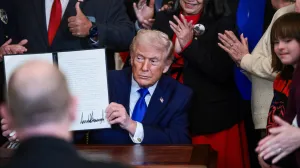 U.S. President Donald Trump holds a proclamation establishing "Angel Family Day", during an event to honor "Angel Families" who have lost family members to crimes committed by people in the country illegally, at the White House in Washington, D.C., U.S., February 23, 2026. REUTERS/Evelyn Hockstein/Evelyn Hockstein