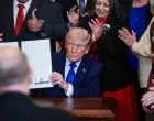 U.S. President Donald Trump holds a proclamation establishing "Angel Family Day", during an event to honor "Angel Families" who have lost family members to crimes committed by people in the country illegally, at the White House in Washington, D.C., U.S., February 23, 2026. REUTERS/Evelyn Hockstein/Evelyn Hockstein