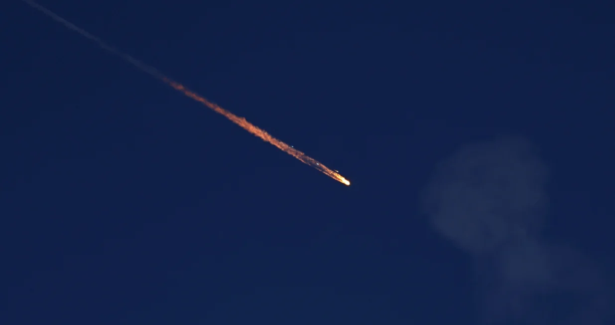 FILE PHOTO: A fragment falls through the sky after Israel's Iron Dome intercepted a missile launched from Iran towards Israel, amid the Iran-Israel conflict, as seen from Ashkelon, Israel June 20, 2025. REUTERS/Amir Cohen/File Photo/Amir Cohen