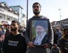 A Shiite Muslim man holds a photo of Iran's Supreme Leader Ayatollah Ali Khamenei, as they protest after Khamenei was killed in Israeli-U.S. strikes on Saturday, in Srinagar, Indian Kashmir March 1, 2026. REUTERS/Sharafat Ali/Sharafat Ali
