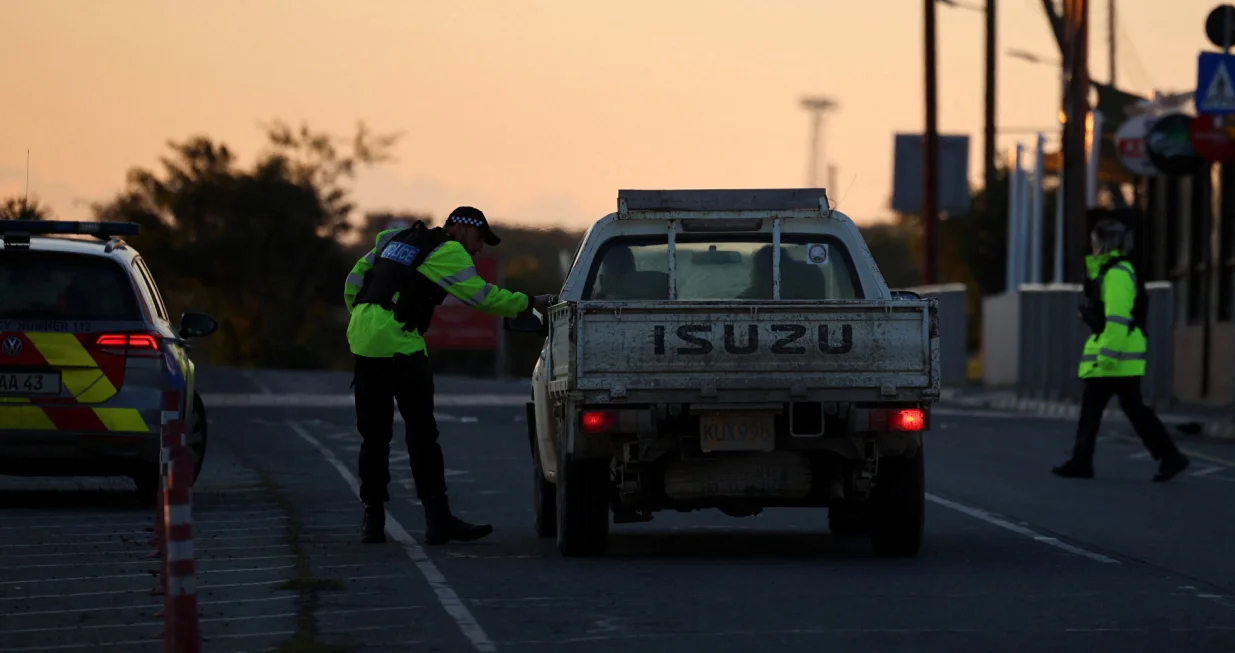 Police check vehicles on the road leading to RAF Akrotiri, a British sovereign base in Cyprus, which was hit by an unmanned drone overnight, causing limited damage, Cyprus March 2, 2026. REUTERS/Yiannis Kourtoglou/Yiannis Kourtoglou