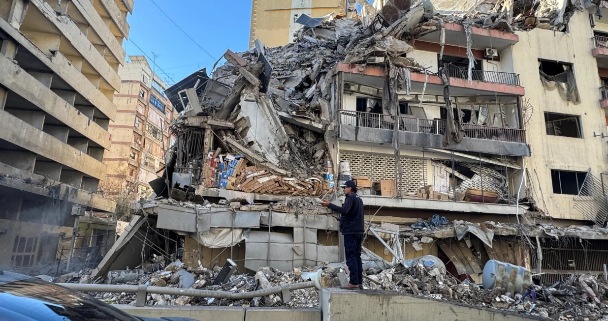 A man stands near a damaged building after Israeli strikes on Beirut's southern suburbs on Wednesday, following renewed hostilities between Hezbollah and Israel amid the U.S.-Israeli conflict with Iran, Lebanon, March 5, 2026. Picture taken with a mobile phone. REUTERS/Ahmad Al Kerdi/Ahmad Al Kerdi