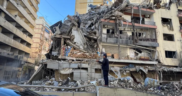 A man stands near a damaged building after Israeli strikes on Beirut's southern suburbs on Wednesday, following renewed hostilities between Hezbollah and Israel amid the U.S.-Israeli conflict with Iran, Lebanon, March 5, 2026. Picture taken with a mobile phone. REUTERS/Ahmad Al Kerdi/Ahmad Al Kerdi