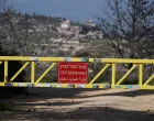 A sign is pictured on the gate from the Israeli side of the border with Lebanon, amid escalation between Hezbollah and Israel, amid the U.S.-Israeli conflict with Iran, in northern Israel, March 6, 2026. REUTERS/Ammar Awad/Ammar Awad