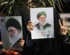 FILE PHOTO: A woman gestures while holding an image of Iran's late Supreme Leader Ayatollah Ali Khamenei, on the day of an anti-Israeli and U.S. rally, amid the U.S.-Israeli conflict with Iran, in Tehran, Iran, March 6, 2026. Majid Asgaripour/WANA (West Asia News Agency) via REUTERS ATTENTION EDITORS - THIS PICTURE WAS PROVIDED BY A THIRD PARTY/File Photo/Majid Asgaripour