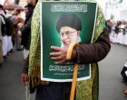 A man holding a poster featuring a picture of late Iran's Supreme Leader Ayatollah Ali Khamenei joins a demonstration with Houthi supporters in solidarity with Iran and Lebanon, amid the U.S.-Israeli conflict with Iran, in Sanaa, Yemen March 6, 2026. REUTERS/Khaled Abdullah/Khaled Abdullah