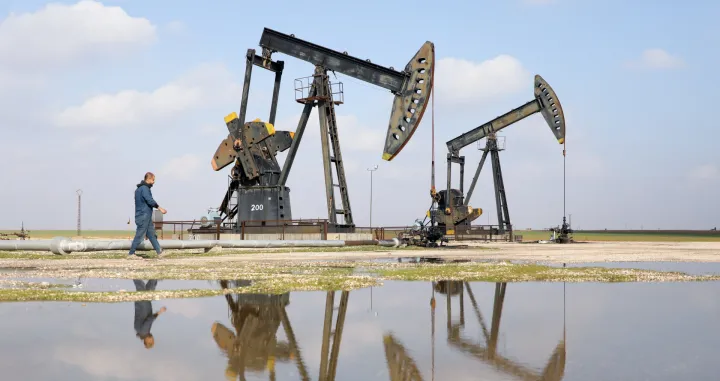 A man walks next to pumpjacks on the day a Syrian government delegation visits the oil-rich city of Rmelan to inspect oil fields and finalise agreements signed between the Syrian government and the Syrian Democratic Forces (SDF), in Rmelan, Syria, February 9, 2026. REUTERS/Orhan Qereman/Orhan Qereman
