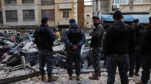 Emergency personnel stand near debris and damaged vehicles at site of an Israeli strike on an apartment building, in central Beirut, Lebanon, March 11, 2026, following an escalation between Hezbollah and Israel amid the U.S.-Israeli conflict with Iran. REUTERS/Emilie Madi/Emilie Madi