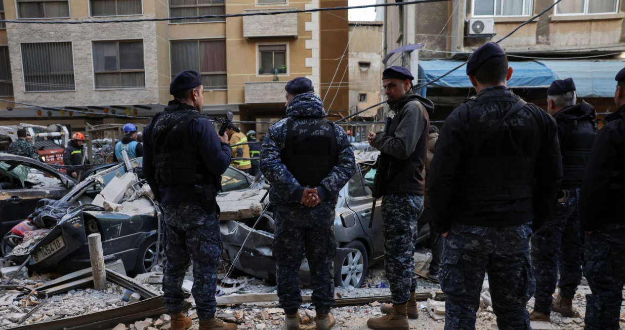 Emergency personnel stand near debris and damaged vehicles at site of an Israeli strike on an apartment building, in central Beirut, Lebanon, March 11, 2026, following an escalation between Hezbollah and Israel amid the U.S.-Israeli conflict with Iran. REUTERS/Emilie Madi/Emilie Madi