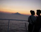 epa08615247 A couple enjoys the sunset on the deck of the ferry boat 'Nissos Mykonos', while sailing in the Aegean sea, Greece, 20 August 2020. EPA/DIMITRIS TOSIDIS/Dimitris Tosidis