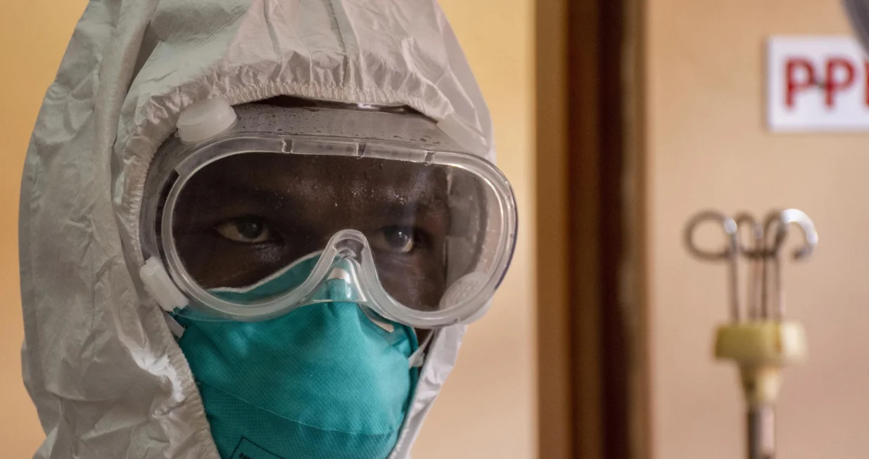 epa10255232 A Ugandan doctor dressing in his Personal Protective Equipments at the Entebbe Regional Referral Hospital Isolation Centre in Entebbe, Uganda, 20 october 2022. A total of 64 positive cases and 24 deaths have so far been confirmed in Uganda since the outbreak of the deadly Ebola virus a month ago in Uganda. EPA/ISAAC KASAMANI/Isaac Kasamani